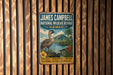 A vintage-style metal sign with a bird and tropical landscape, mounted on a wooden wall.