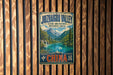 A vintage-style metal sign for the Juzhaigou Valley in China, featuring a scenic landscape with mountains, water, and a waterfall.