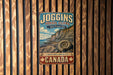 A vintage-style metal sign advertising Joggins Fossil Cliffs, a world heritage site in Canada, with a scenic illustration of a cliff and a spiral fossil.