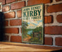 A vintage-style sign for John Henry Kirby State Forest in Texas, featuring a scenic landscape with a lake and forest.