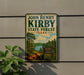 A vintage-style sign for John Henry Kirby State Forest in Texas, featuring a scenic landscape with a lake and pine trees.
