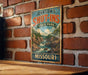 A vintage-style metal sign for Johnson's Shut-Ins State Park in Missouri, featuring a scenic landscape with a river and mountains.