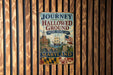 A vintage metal sign with the text "Journey Through Hallowed Ground" and "National Heritage Area" hangs on a wooden wall.
