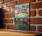 A vintage-style metal sign with the text "Journey Through Hallowed Ground" and "National Heritage Area Virginia" hangs on a brick wall.