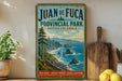 A vintage-style sign for Juan de Fuca Provincial Park in British Columbia, Canada, featuring a scenic coastal landscape with rocky cliffs, pine trees, and a blue ocean.