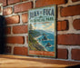 A vintage-style sign for Juan de Fuca Provincial Park in British Columbia, Canada, featuring a scenic coastal landscape with mountains, trees, and a body of water.