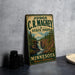 A vintage-style metal sign for C.R. Magney State Park in Minnesota, featuring a scenic illustration of a waterfall surrounded by pine trees.