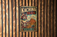 A vintage metal sign with the text "Kachina Trail" and "Discover the Spirit of Arizona" is displayed on a wooden wall.