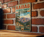 A vintage-style metal sign for Kaibab National Forest in Arizona, featuring a scenic mountain landscape and the words "Explore, Discover, Protect" in bold letters.