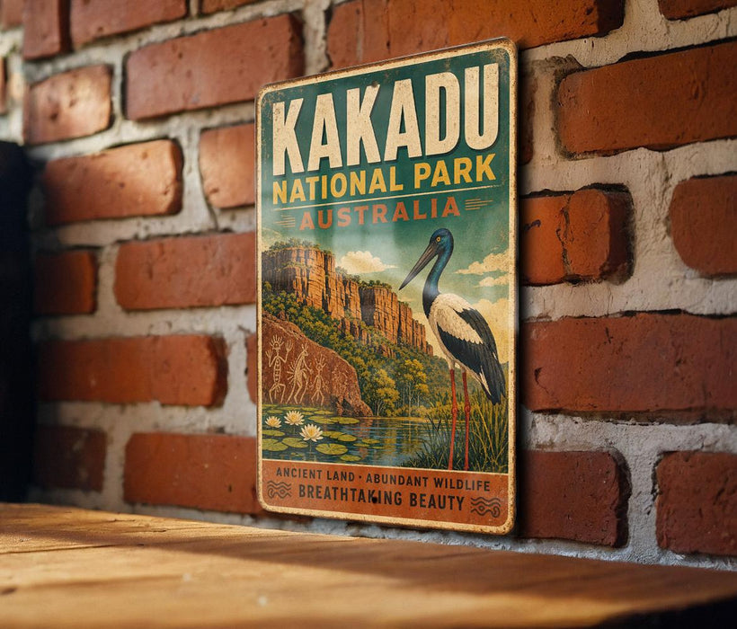 A vintage-style sign for Kakadu National Park in Australia, featuring an illustration of a bird and a landscape with a river and mountains.