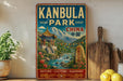 A vintage-style metal sign for Kanbula Park in China, featuring a traditional Chinese temple and a scenic landscape with a river and mountains.