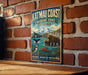 A vintage-style metal sign for the Katmai Coast Marine Zone in Alaska, featuring an illustration of wildlife such as a bear, puffin, and salmon.