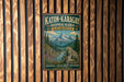 A vintage-style metal sign for the Katon-Karagay Biosphere Reserve in Kazakhstan, featuring a mountain landscape with a leopard.
