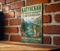 A vintage-style metal sign with a mountain landscape and a leopard, mounted on a brick wall.