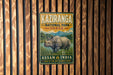 A vintage-style metal sign for Kaziranga National Park, India, featuring an illustration of a rhinoceros in a grassy field with mountains in the background.