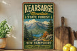 A vintage-style sign for the state forest in New Hampshire, featuring a mountain landscape and the text "Kearsarge Mountain State Forest New Hampshire Live Free".