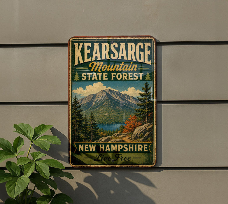 A vintage metal sign for the Kearsarge Mountain State Forest in New Hampshire, featuring a scenic mountain landscape with pine trees and a lake.