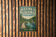 A vintage metal sign for Keeney Swamp State Forest in New York, featuring a wooden boardwalk leading to a pond with a crane standing on it.