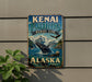 A vintage-style sign for Kenai Fjords, Alaska, featuring a whale and other marine life against a backdrop of mountains.