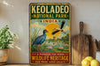 A vintage-style metal sign for Keoladeo National Park in India, featuring a blue bird and a seagull in a natural setting with a sun and water.