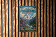 A vintage-style metal sign for Khangchenzonga National Park in India, featuring a mountain landscape with flowers and a river.