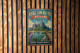 A vintage-style metal sign with the text "KHOA SAM ROI YOT WETLAND Thailand" and an illustration of a serene landscape with mountains, a lake, and a bird.