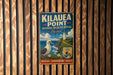 A vintage-style metal sign for the National Wildlife Refuge in Hawaii, featuring a lighthouse and a seagull, mounted on a wooden wall.