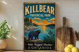 A vintage-style metal sign for Killbear Provincial Park in Ontario, featuring a bear in a scenic landscape with a sunset and pine trees.