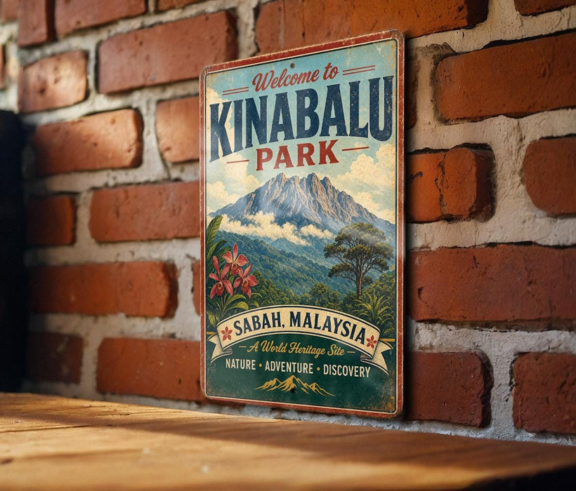 A vintage metal sign with the text "Welcome to Kinabalu Park" and a mountain landscape, mounted on a brick wall.