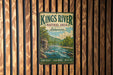 A vintage metal sign for the Kings River Natural Area in Arkansas, featuring a scenic illustration of a river surrounded by mountains and lush greenery.