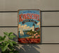 A vintage-style metal sign welcoming visitors to Kingscote, Rhode Island, with a lighthouse and a sailboat in the background.
