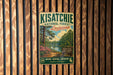 A vintage-style metal sign for the Kisatchie National Forest in Louisiana, featuring a scenic landscape with pine trees, a lake, and a sign indicating the area as a Longleaf Pine forest.