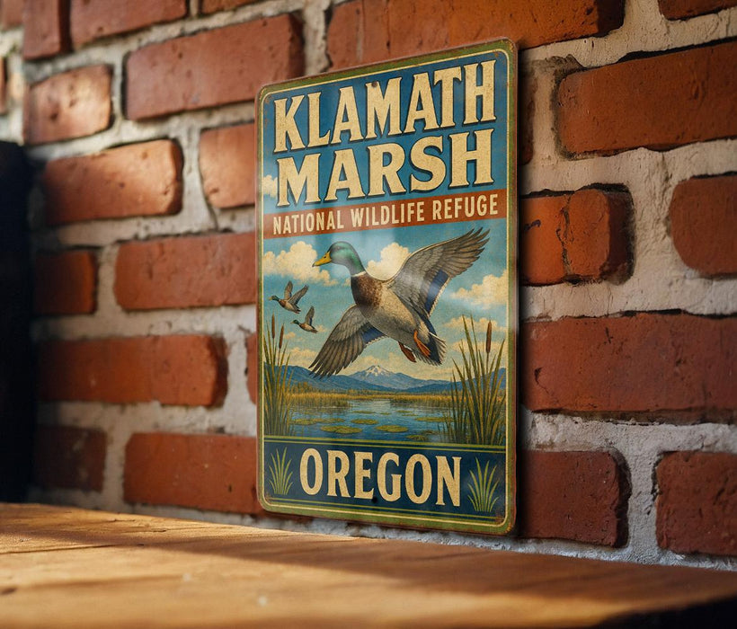 A vintage-style metal sign for Klath Marsh National Wildlife Refuge in Oregon, featuring a duck and a landscape with mountains in the background.