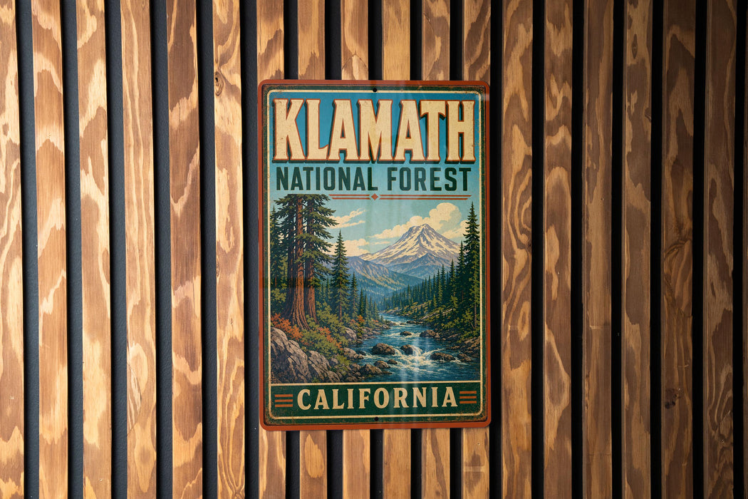 A vintage-style metal sign for Klath National Forest in California, featuring a scenic landscape with a mountain, river, and pine trees.