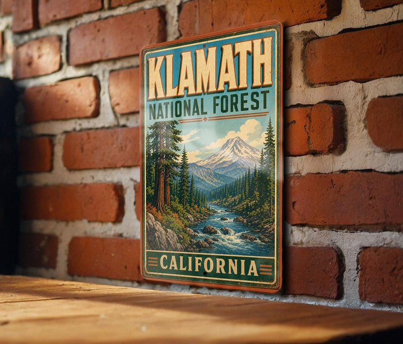 A vintage-style metal sign for Klath National Forest in California, featuring a scenic mountain landscape with pine trees and a river flowing through the forest.