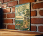 A vintage-style metal sign for Knobstone Trail in Indiana, featuring a scenic mountain landscape and hiking trail information.