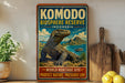 A vintage-style sign for Komodo Island, Indonesia, featuring a large illustration of a Komodo dragon and the text "Komodo Biosphere Reserve Indonesia" and "World Heritage Site - Protect Nature, Preserve Life".