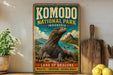 A vintage-style metal sign for Komodo National Park in Indonesia, featuring a large illustration of a Komodo dragon in a natural landscape.