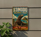 A vintage-style metal sign for Komodo National Park in Indonesia, featuring an illustration of a Komodo dragon.