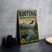 A vintage-style metal sign for the Kootenai National Wildlife Refuge in Idaho, featuring an illustration of wildlife and mountains.
