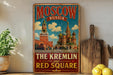 A vintage-style poster of Moscow, Russia, featuring the Kremlin and the Red Square, is displayed on a wall next to a wooden cutting board and some lemons.