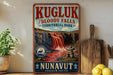 A vintage-style sign for Kugluk/Bloody Falls, a remote park in Nunavut, Canada, featuring a waterfall and a stone structure.