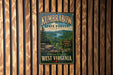 A vintage-style metal sign for the Kumbarow State Forest in West Virginia, featuring a scenic landscape with a lake and mountains.