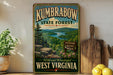 A vintage-style metal sign for Kumbrella State Forest in West Virginia, featuring a scenic landscape with mountains, trees, and a lake.