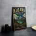 A vintage-style metal sign for Kuskawa Territorial Park in Yukon, Canada, featuring a scenic mountain landscape.