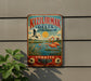 A vintage metal sign with a colorful illustration of flamingos and a bird in flight, along with text in Turkish, hanging on a wall.