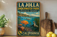 A vintage-style metal sign for La Jolla Underwater Park, an ecological reserve in California, featuring an illustration of marine life and a coastal landscape.