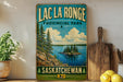 A vintage-style sign for Lac La Ronge Provincial Park in Saskatchewan, featuring a scenic landscape with pine trees, a lake, and a small island.