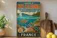 A vintage-style poster of the Lagoon of New Caledonia, featuring a seascape with a sailboat, coral reefs, and marine life.