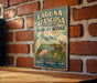 A vintage-style metal sign for the Laguna Atascosa National Wildlife Refuge in Texas, featuring illustrations of wildlife and a serene landscape.